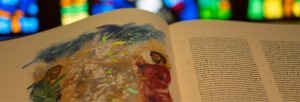 Photo taken of the St John’s Bible in the Regis College Chapel, with the Saint John’s Bible opened to the Transfiguration. Showing Transfiguration, Donald Jackson with contributions from Aidan Hart, Copyright 2002, The Saint John’s Bible, Saint John’s University, Collegeville, Minnesota USA, Scripture quotations are from the New Revised Standard Version of the Bible, Catholic Edition, Copyright 1993, 1989 National Council of the Churches of Christ in the United States of America. Used by permission. All rights reserved.